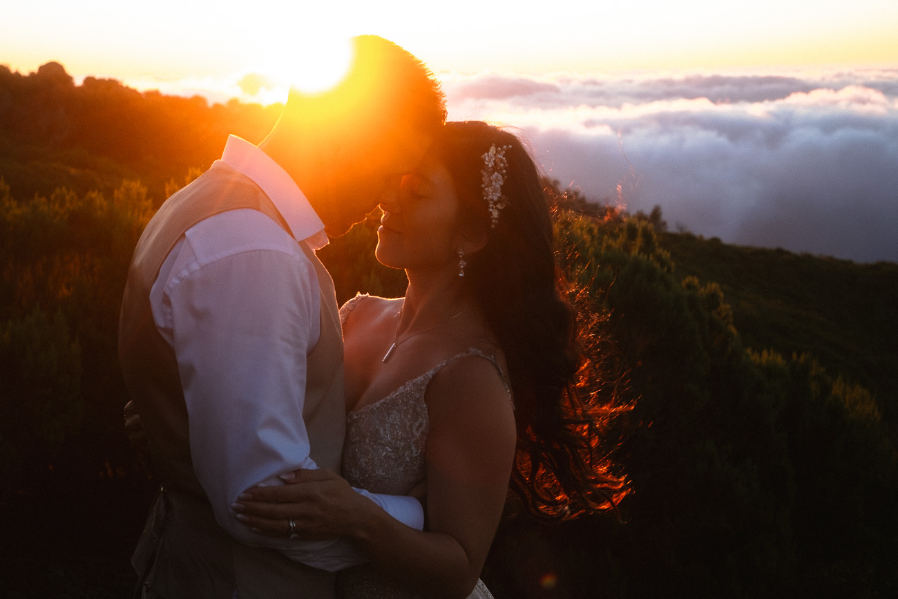 A bride and groom enjoying the sunrise on Pico Ruivo
