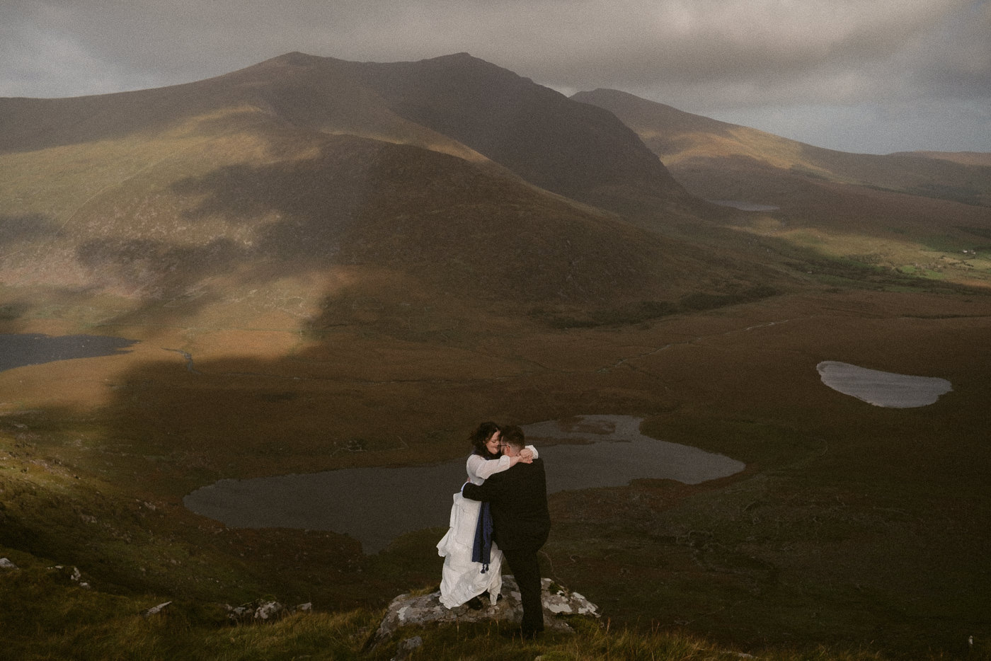 A bride and groom exploring Conor Pass during their Dingle Elopement in Ireland