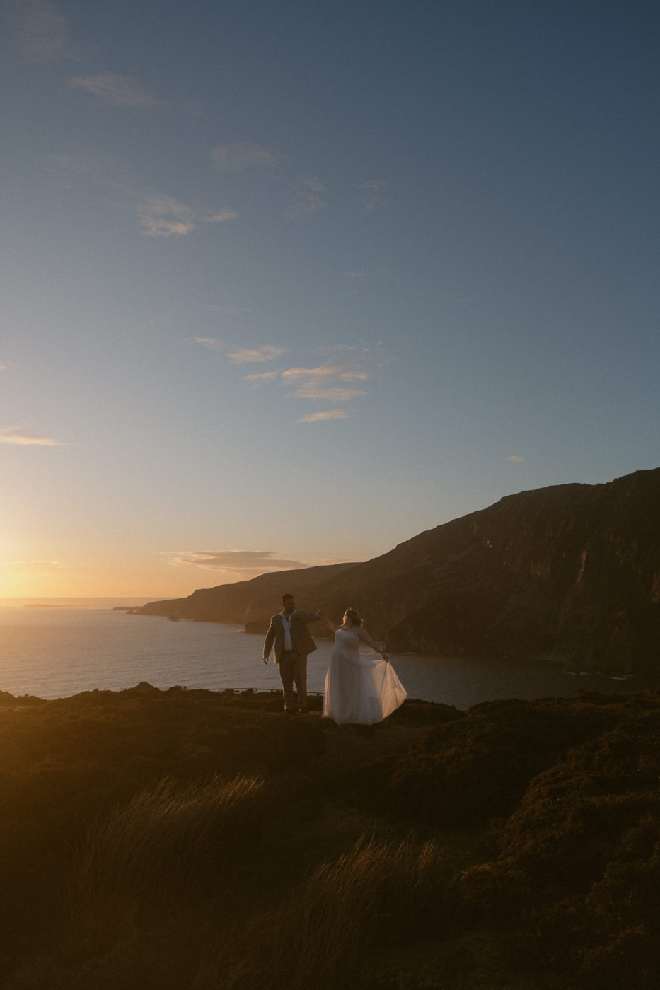 A elopement couple dancing at sunset at the Slieve League Cliffs in Ireland