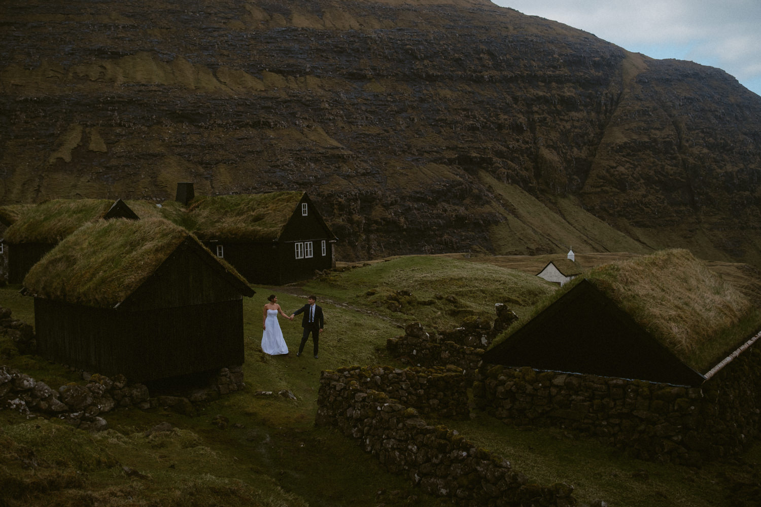 Adventurous elopement photo in Saksun village in the Faroe Islands