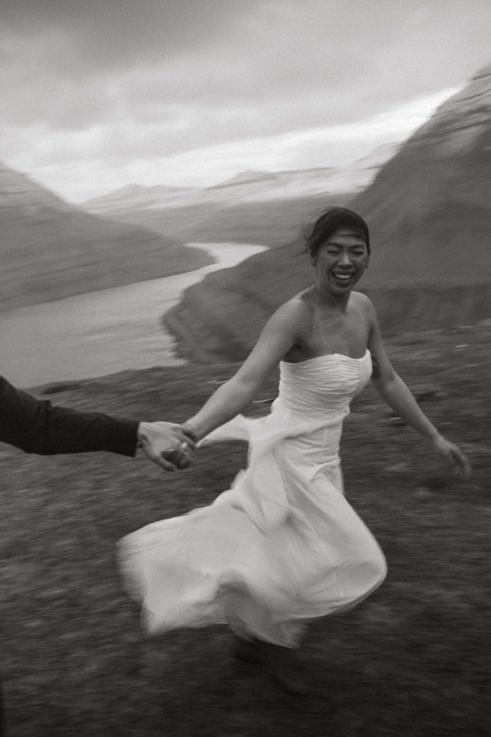 Blurry photo of a bride running and laughing during her elopement day in the Faroe Islands