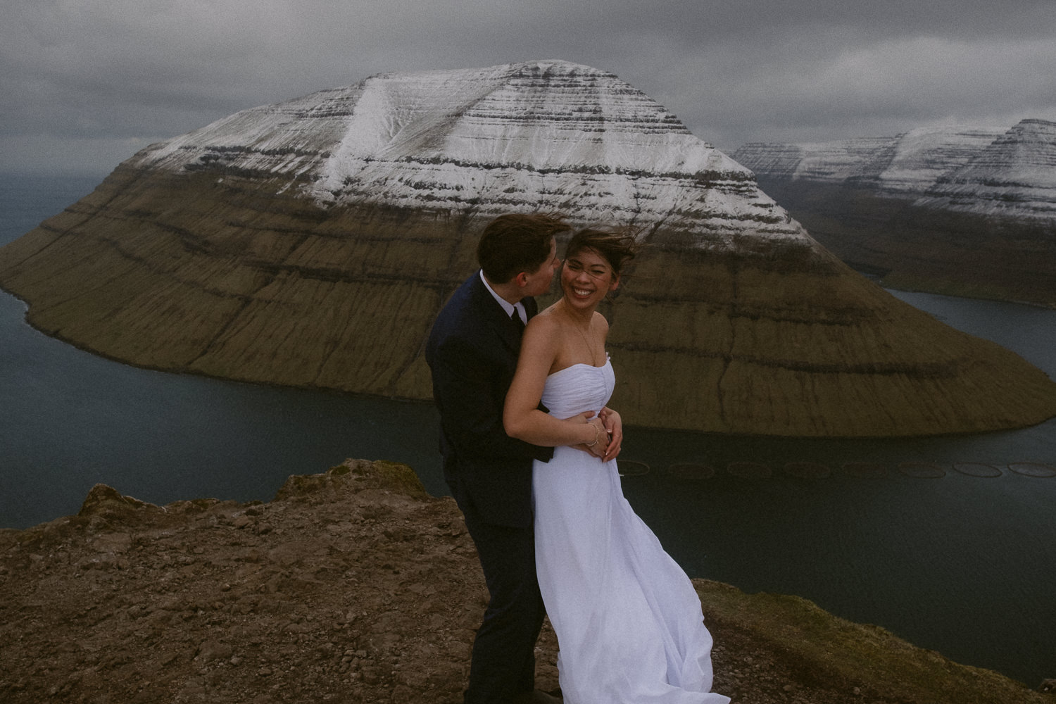 Faroe Islands elopement couple walking smiling on Klakkur Mountain in May