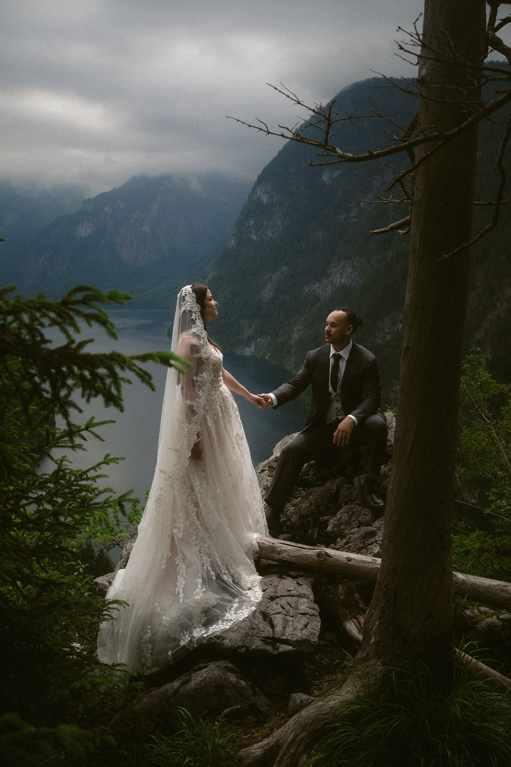 A bride and groom at a viewpoint during their lake Königssee elopement